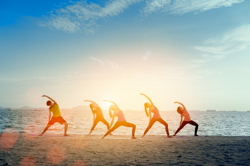 group-man-and-woman-yoga-practice-on-mat-relaxation-in-class-exercise-with-pose-fitness-sport-for-healthy-on-the-beach-and-seaside